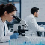 Representative image of oncology researchers studying tumor biology in a modern laboratory, reflecting Exelixis’ CABINET trial data on CABOMETYX and its potential role in advanced neuroendocrine tumor treatment.