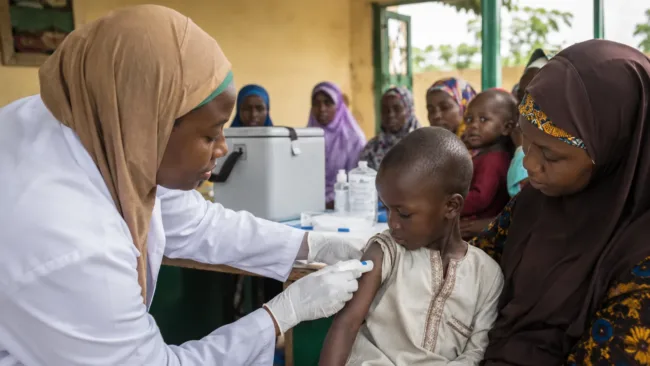 Representative image of a child receiving a needle-free polio vaccine during a community immunisation campaign, highlighting PharmaJet’s Tropis system and Nigeria’s push to close vaccine coverage gaps.